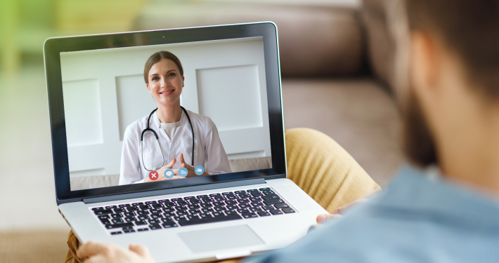 Stethoscope and laptop on doctor working desk with blurred focus for background, business and health care concept
